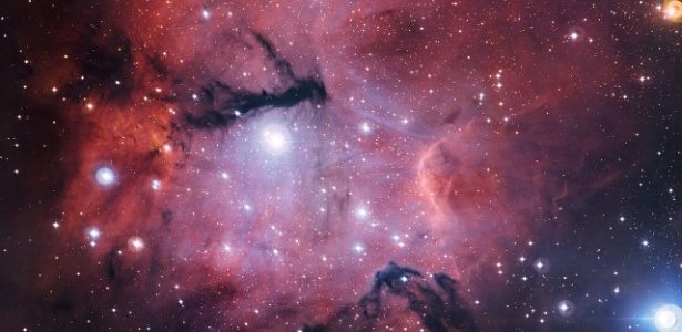 A nuvem de gás e poeira cósmica Gum 15 tem aparência irregular devido à distribuição das estrelas e do gás 