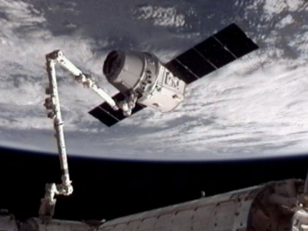 A cápsula espacial Dragon, da empresa SpaceX, se acopla à da Estação Espacial Internacional (ISS, na sigla em inglês). A nave foi capturada pelo braço mecânico da ISS às 10h56 (horário de Brasília) e a acoplagem foi concluída às 13h02. (Foto: AP/Nasa)