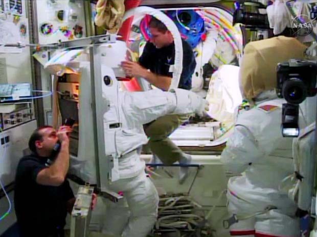 Astronautas na Estação Espacial Internacional verificam traje para caminhada espacial (Foto: NASA TV)