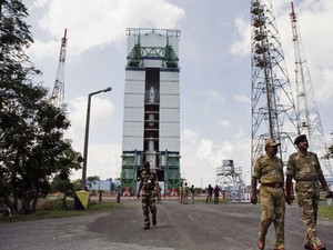 Funcionários andam perto do Veículo de Lançamento de Satélite Polar (PSLV ? C25) no Centro Espacial Satish Dhawan em Sriharikota, no sul da Índia. Esta é a primeira missão da Índia rumo ao planeta Marte. (Foto: AP Photo/Arun Sankar K.)
