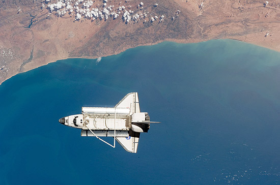 Ônibus espacial Discovery é visto da Estação Espacial Internacional com a costa do Marrocos