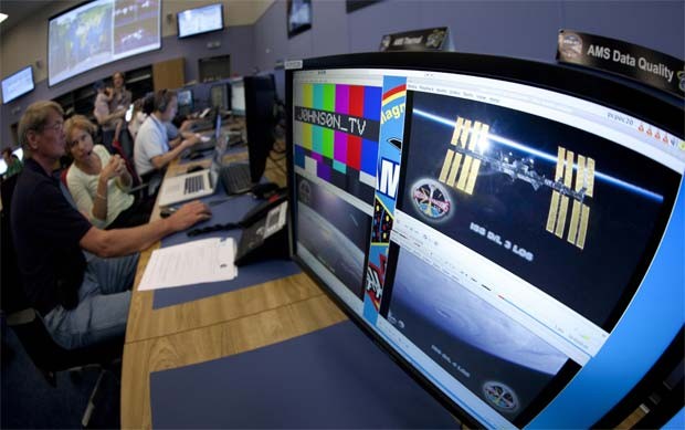 Imagem da ISS aparece em monitor no Cern, na Suíça, durante visita de astronautas que levaram o espectrômetro ao espaço. (Foto: Reuters)